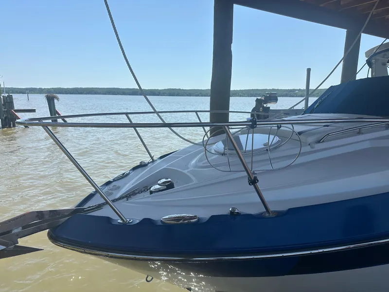 Slide: The Image of 2019 Monterey 295 Sport Yacht docked by the water. - 2