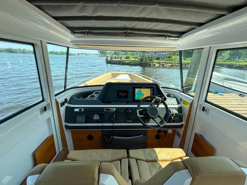 Slide: The Image of Interior view of 2021 Axopar 28 CABIN boat with steering wheel and navigation system. - 15