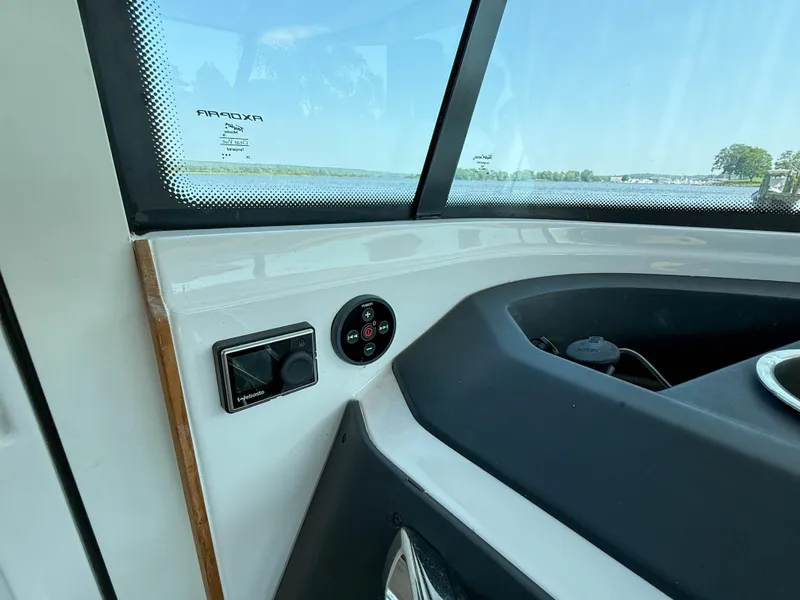 Slide: The Image of Interior view of 2021 Axopar 28 CABIN boat dashboard with controls and window. - 19