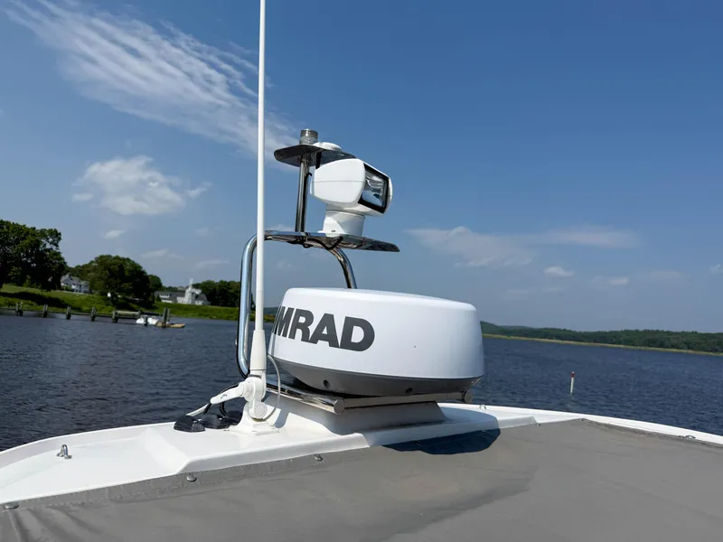 Slide: The Image of Axopar 28 CABIN 2021 boat with radar system on a sunny day by the water. - 23