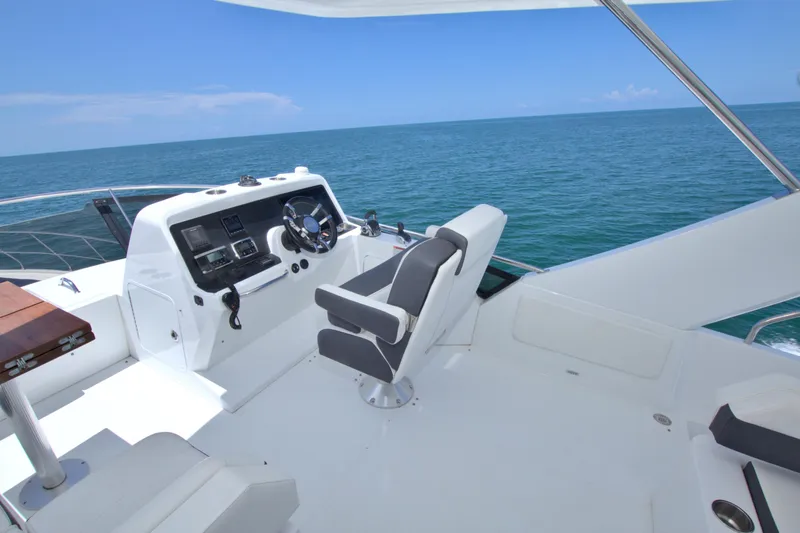 Slide: The Image of 2018 Cruisers Yachts 54 Fly bridge with ocean view and modern helm station. - 14