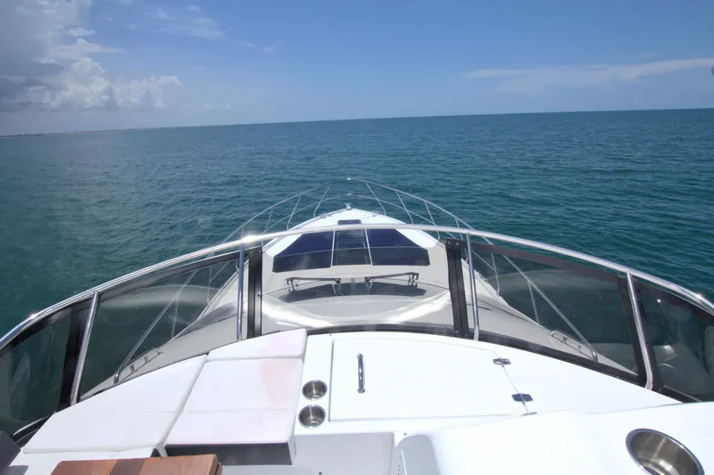 Slide: The Image of 2018 Cruisers Yachts 54 Fly on open sea, clear sky, luxurious deck view. - 16