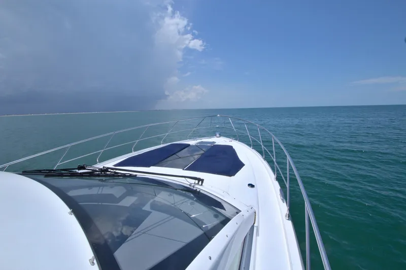 Slide: The Image of 2018 Cruisers Yachts 54 Fly on open sea under clear blue sky. - 22