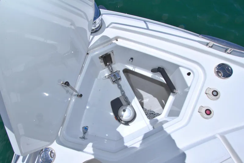 Slide: The Image of Anchor compartment of 2018 Cruisers Yachts 54 Fly, featuring chain and controls. - 25