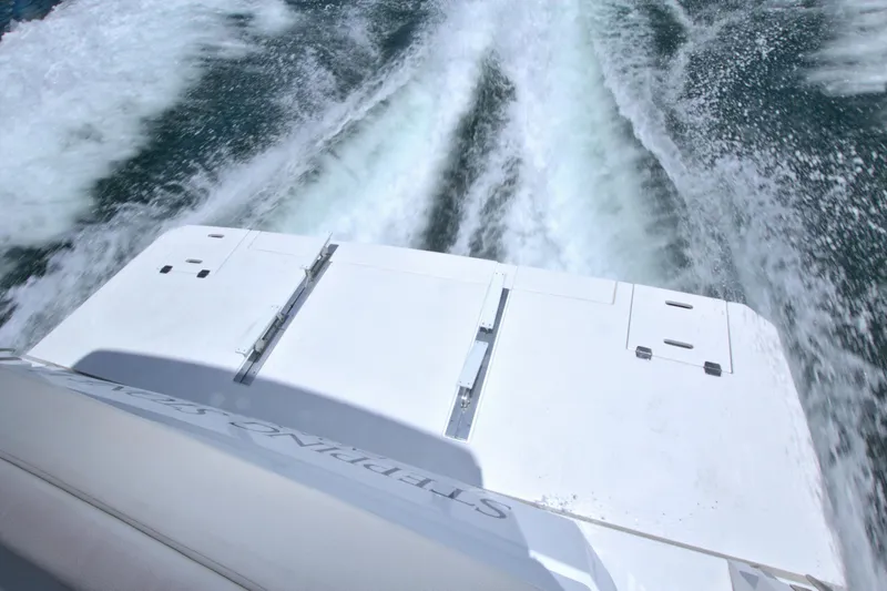 Slide: The Image of 2018 Cruisers Yachts 54 Fly leaving a wake on the water. - 31