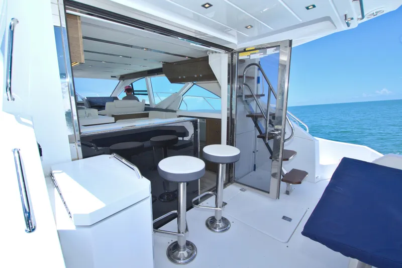 Slide: The Image of Luxurious 2018 Cruisers Yachts 54 Fly interior with ocean view and modern seating. - 32