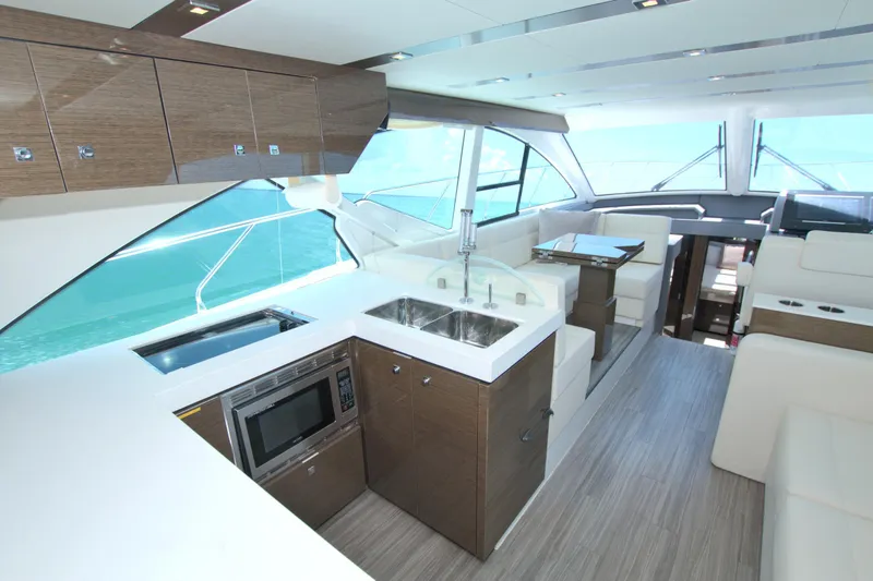 Slide: The Image of Luxurious interior of 2018 Cruisers Yachts 54 Fly with modern kitchen and seating area. - 38