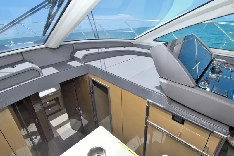 Slide: The Image of 2018 Cruisers Yachts 54 Fly helm with modern navigation system and ocean view. - 45