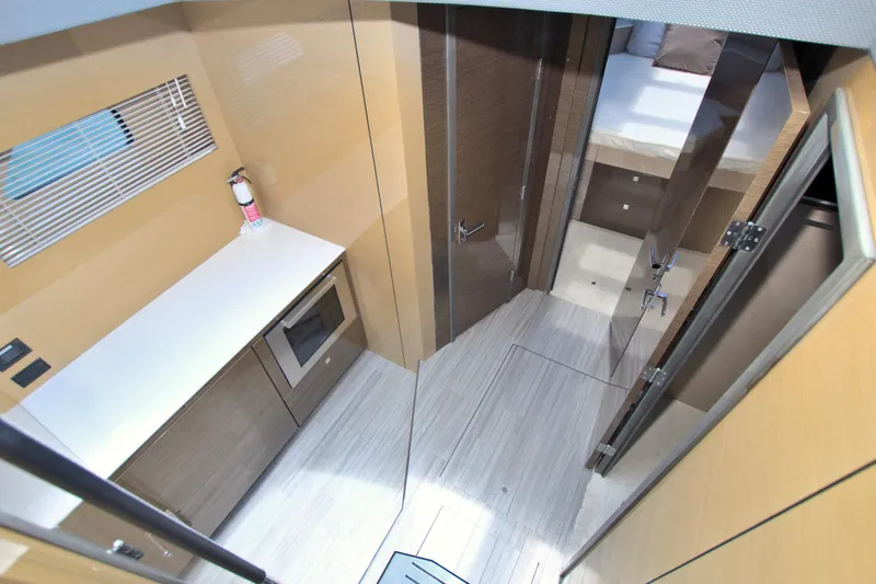 Slide: The Image of 2018 Cruisers Yachts 54 Fly interior with modern kitchen and cozy bedroom. - 47