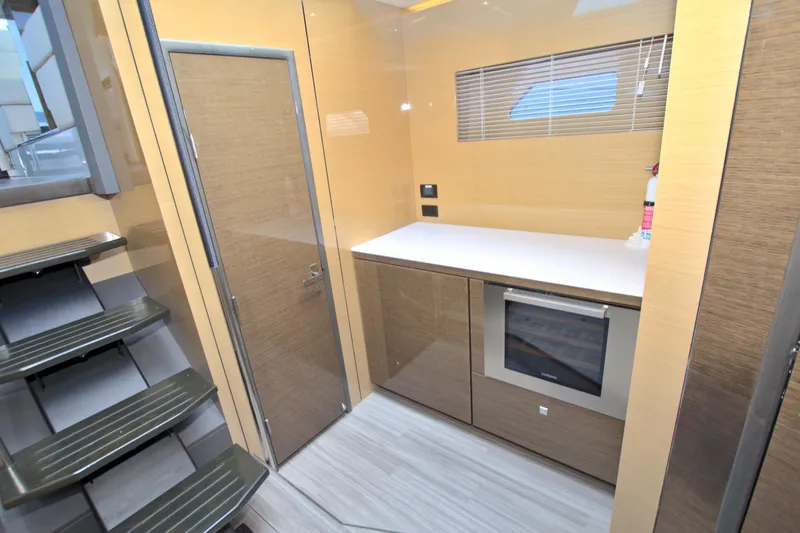 Slide: The Image of Modern galley kitchen in 2018 Cruisers Yachts 54 Fly, featuring sleek cabinetry and appliances. - 48