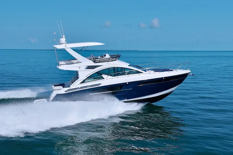 Slide: The Image of 2018 Cruisers Yachts 54 Fly cruising on open water, showcasing sleek design and luxury. - 5
