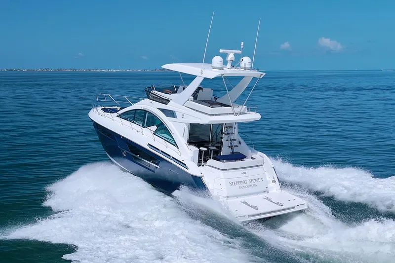 Slide: The Image of 2018 Cruisers Yachts 54 Fly cruising on open water, rear view. - 9