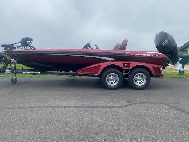 The Image of 2025 Ranger Z519R boat on trailer, red and black design, parked outdoors. - 0