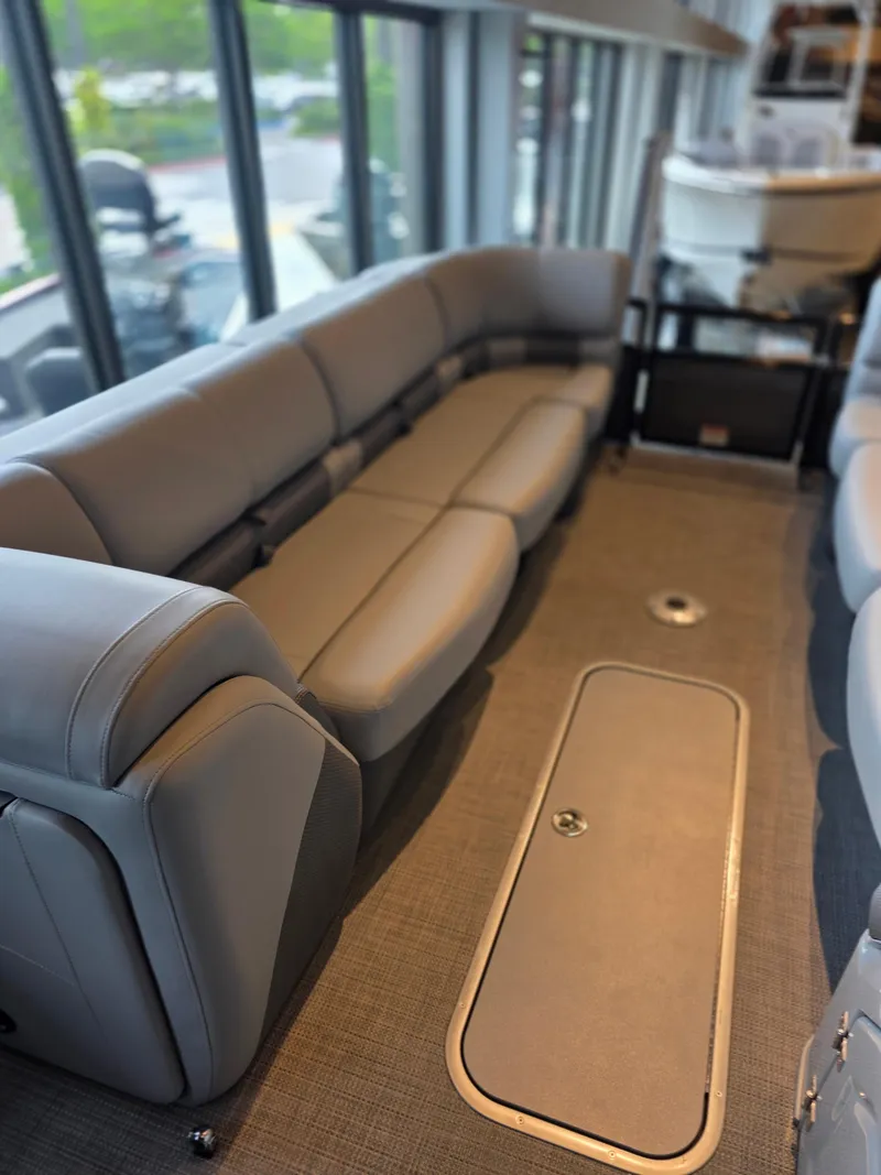 Slide: The Image of Luxurious interior of 2025 Regency 250 LE3 pontoon boat with plush seating. - 3