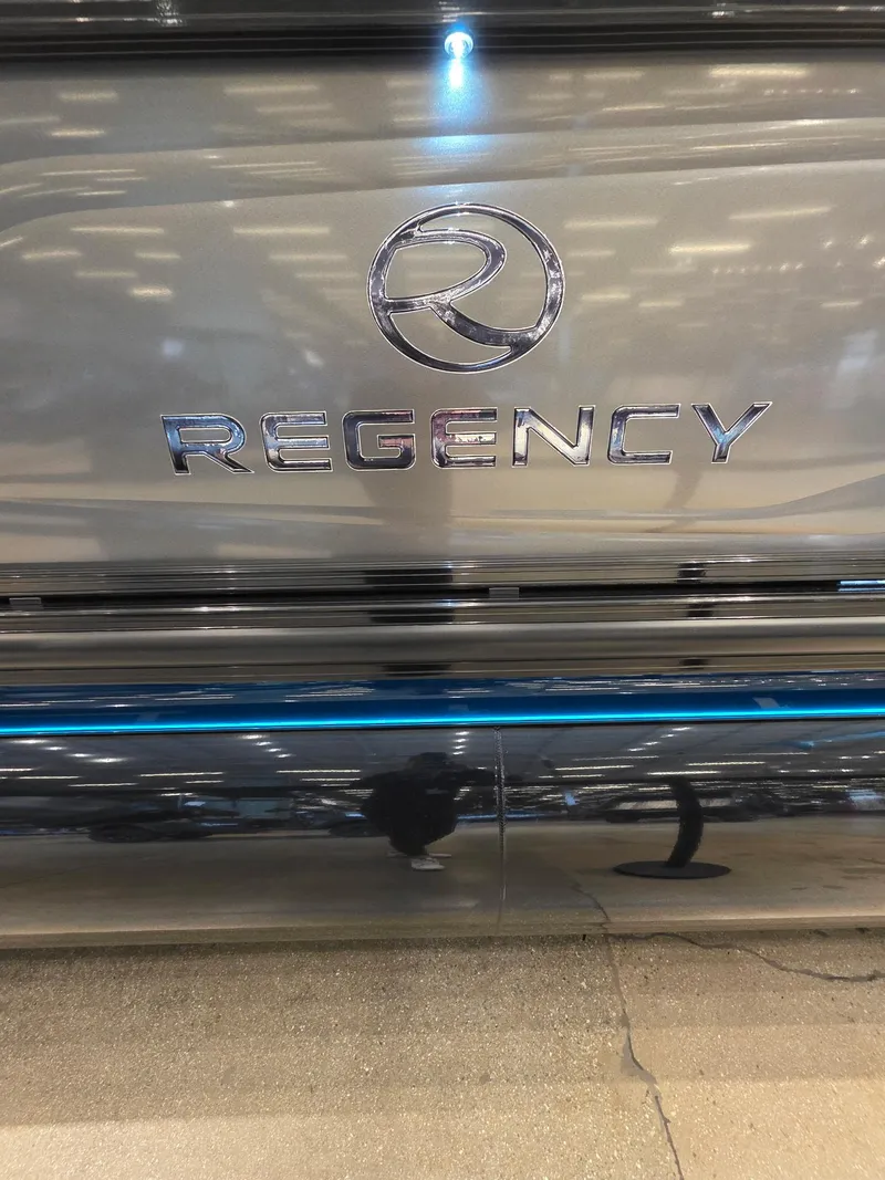 Slide: The Image of 2025 Regency 250 LE3 logo on a sleek, reflective surface with ambient lighting. - 9