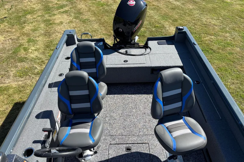 Slide: The Image of 2025 Ranger VS1882SC Reata boat interior with four seats and motor on grassy background. - 4