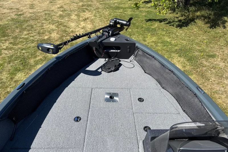 Slide: The Image of 2025 Ranger VS1882SC Reata boat deck with trolling motor, on grassy background. - 3