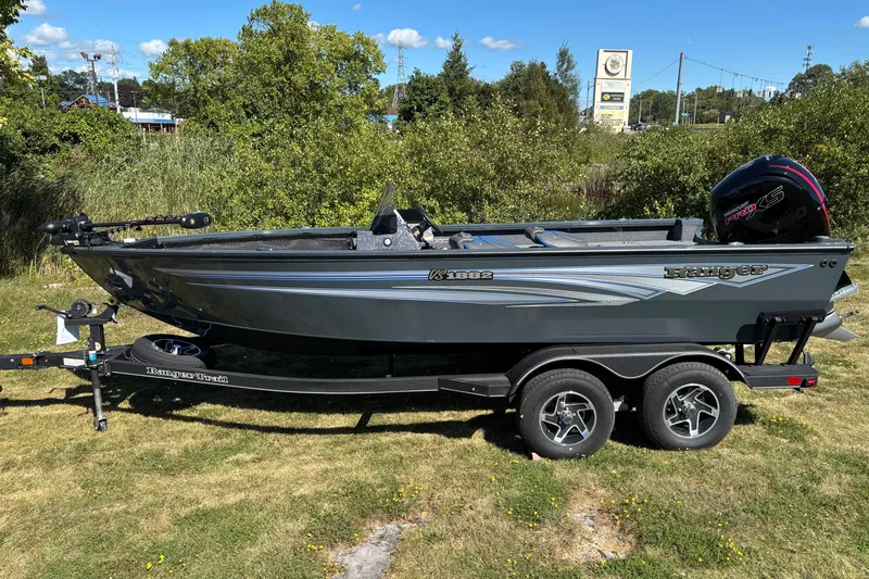 The Image of 2025 Ranger VS1882SC Reata boat on trailer, parked on grass with trees in background. - 0