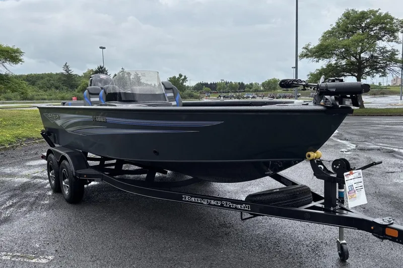 Slide: The Image of 2025 Ranger VS1882SC Reata boat on trailer in parking lot, overcast sky. - 2