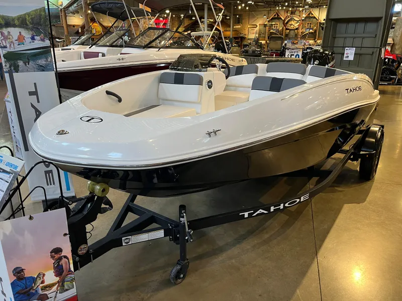 The Image of 2025 Tahoe T16 boat on display in showroom, featuring sleek design and modern seating. - 0