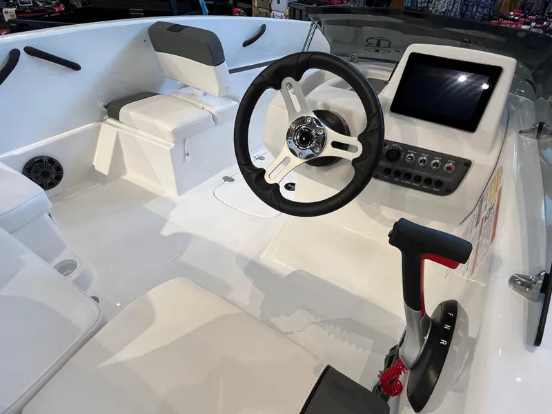Slide: The Image of 2025 Tahoe T16 boat interior with steering wheel, control panel, and seating. - 5