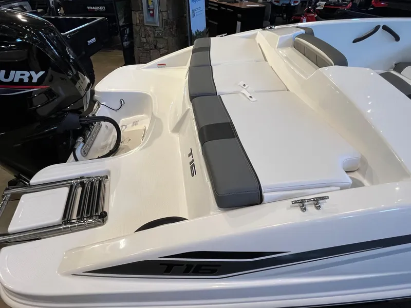 Slide: The Image of 2025 Tahoe T16 boat with Mercury engine, featuring sleek white and gray seating. - 6