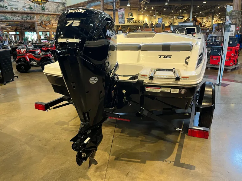 Slide: The Image of 2025 Tahoe T16 boat with Mercury 75 engine displayed indoors. - 7