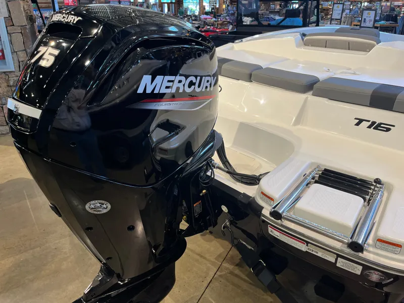 Slide: The Image of 2025 Tahoe T16 boat with Mercury 75 horsepower outboard engine displayed indoors. - 8