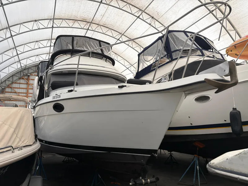 The Image of 1988 Cooper Prowler boat stored in a covered marina, showcasing its sleek design. - 0