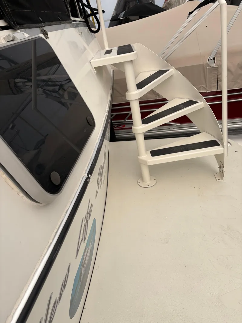 Slide: The Image of White spiral staircase on a 1988 Cooper Prowler boat deck. - 10