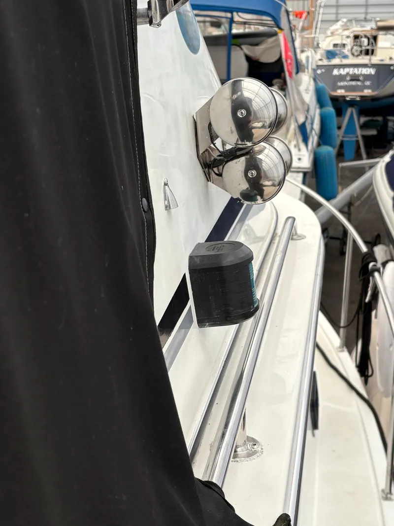 Slide: The Image of Coiled green hose on 1988 Cooper Prowler boat deck, near railing and fittings. - 14