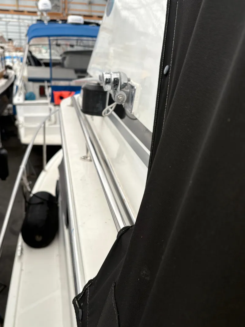 Slide: The Image of 1988 Cooper Prowler boat side view, showcasing sleek design and windows. - 15