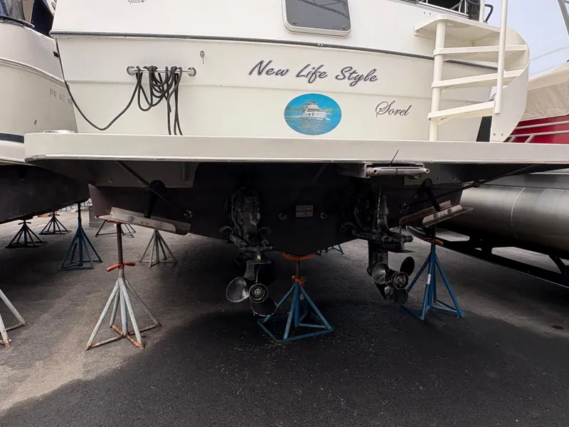 Slide: The Image of 1988 Cooper Prowler boat on stands, rear view with propellers visible. - 2