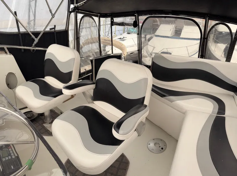 Slide: The Image of 1988 Cooper Prowler yacht in storage, featuring a covered deck and protective canopy. - 20