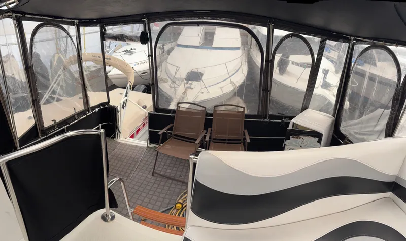 Slide: The Image of 1988 Cooper Prowler boat in storage, featuring a sleek white deck and covered cockpit. - 21