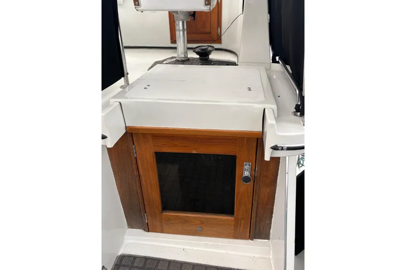 Slide: The Image of 1988 Cooper Prowler boat interior with wooden cabinet and white countertop. - 31