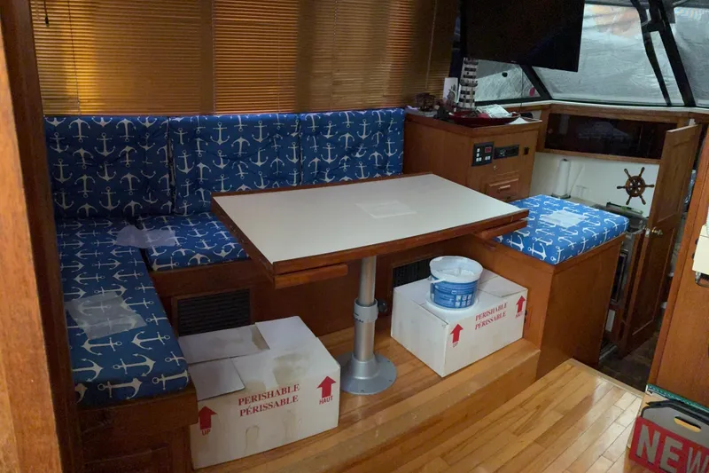 Slide: The Image of 1988 Cooper Prowler boat interior with anchor-patterned seating and wooden accents. - 33