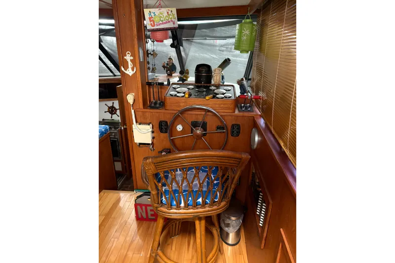 Slide: The Image of 1988 Cooper Prowler boat helm with wooden steering wheel and nautical decor. - 34