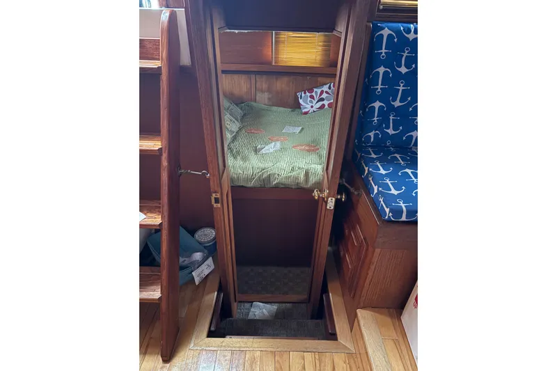 Slide: The Image of Cozy cabin interior of 1988 Cooper Prowler with wooden finish and nautical decor. - 35