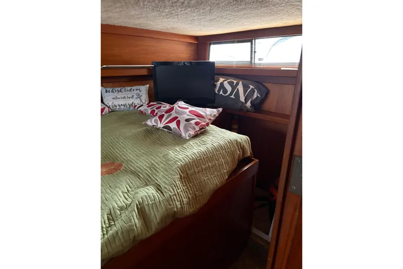 Slide: The Image of Cozy bedroom interior of 1988 Cooper Prowler with pillows and a small TV. - 37