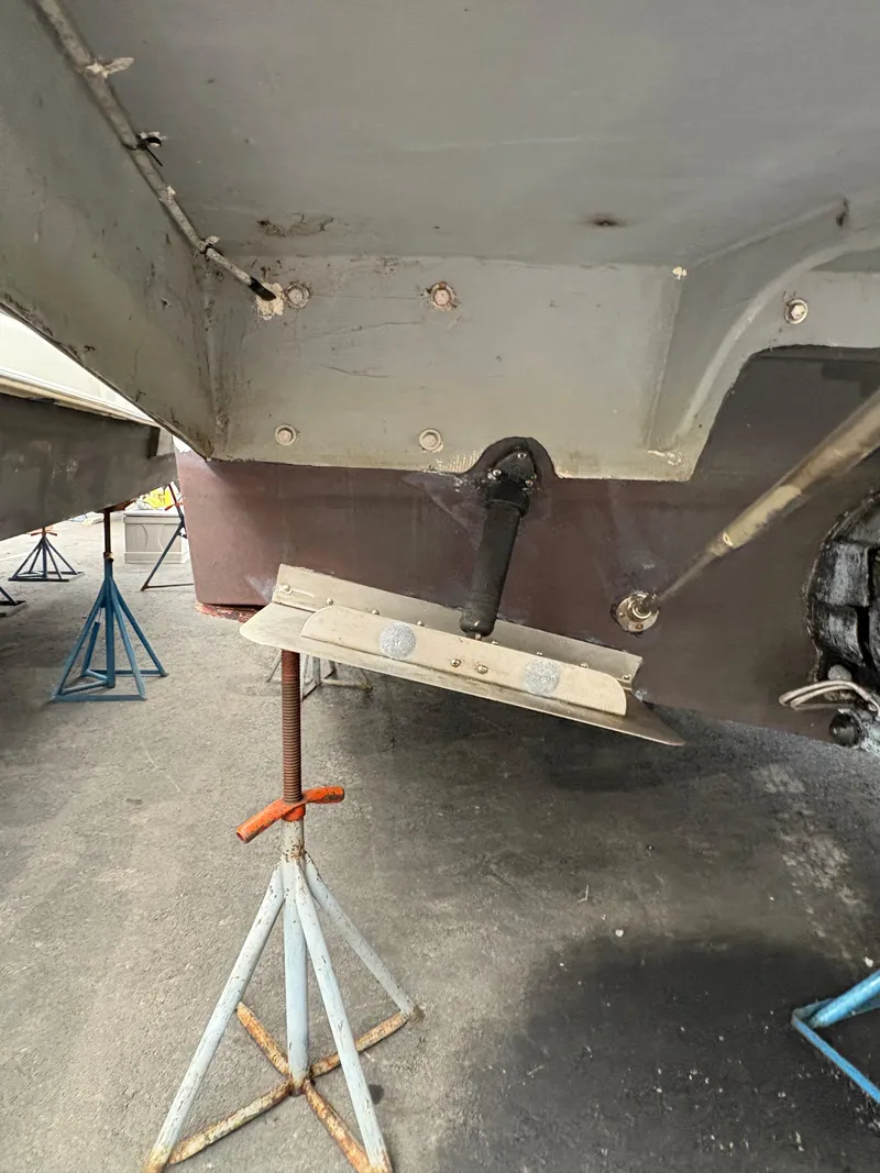 Slide: The Image of 1988 Cooper Prowler boat hull on stands, showing underside details and support structure. - 4