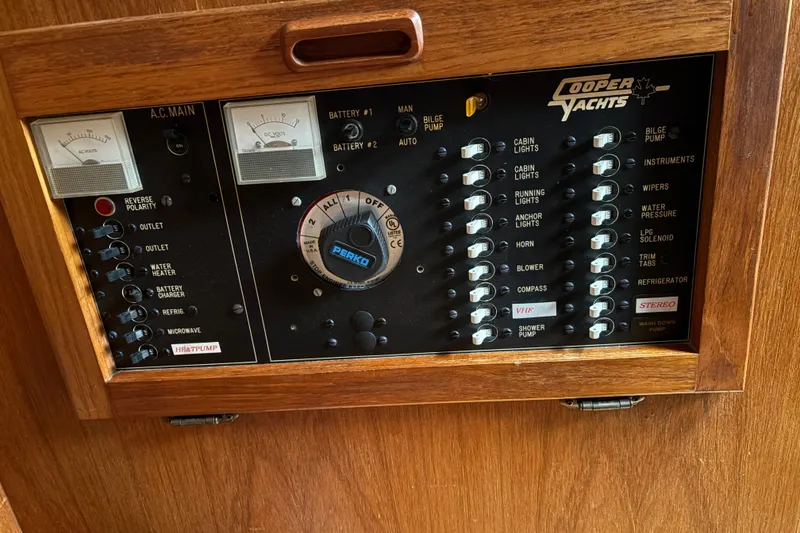 Slide: The Image of 1988 Cooper Prowler yacht control panel with switches and gauges in wooden frame. - 45