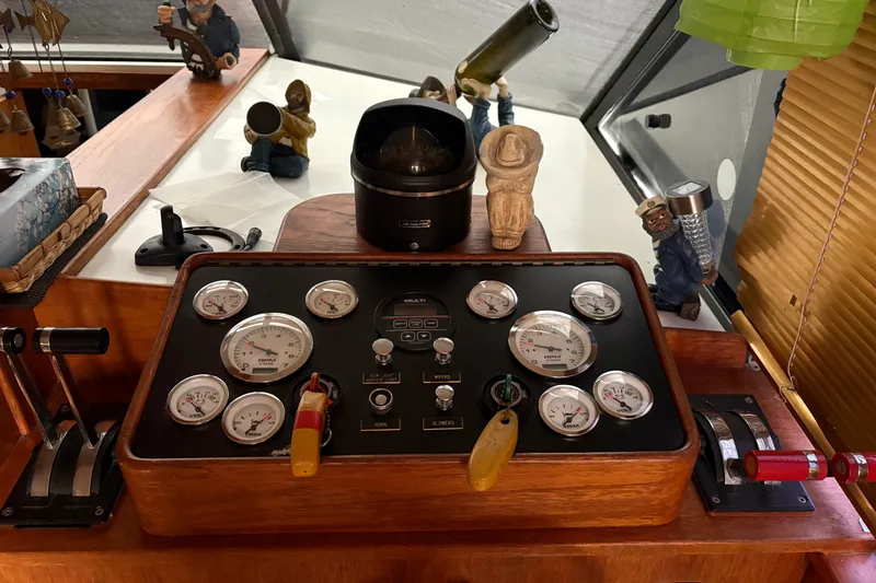 Slide: The Image of Control panel of a 1988 Cooper Prowler boat with gauges and nautical decor. - 51