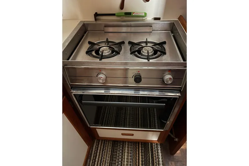 Slide: The Image of 1988 Cooper Prowler kitchen stove with two burners and an oven in a compact space. - 58