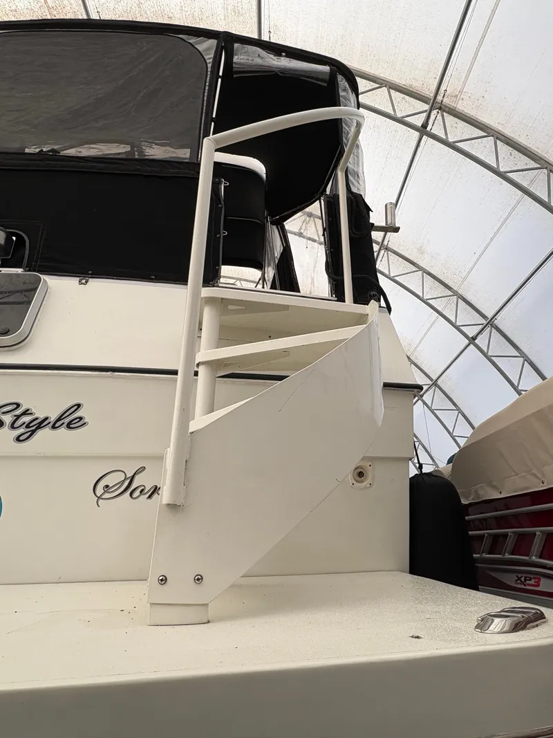 Slide: The Image of 1988 Cooper Prowler boat with spiral staircase under a canopy. - 6