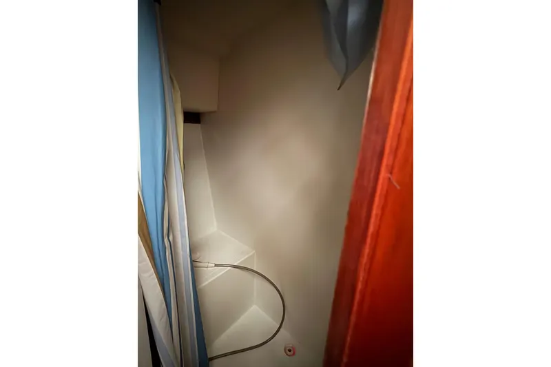 Slide: The Image of 1988 Cooper Prowler interior shower area with curtain and hose. - 64