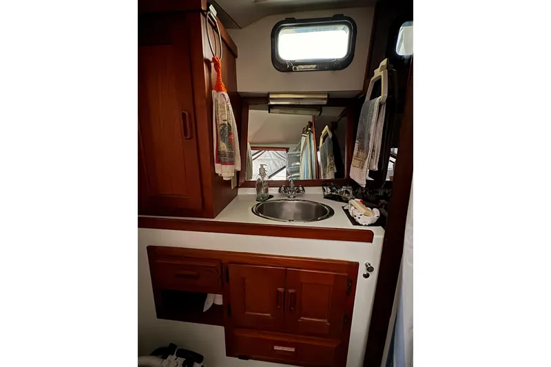 Slide: The Image of 1988 Cooper Prowler bathroom with wooden cabinetry, sink, and window. - 65