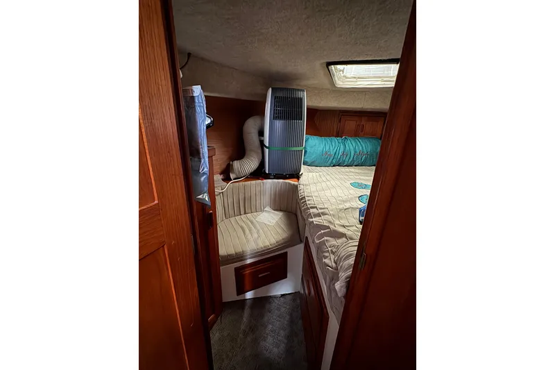 Slide: The Image of Cozy cabin interior of 1988 Cooper Prowler boat with bed and seating area. - 66