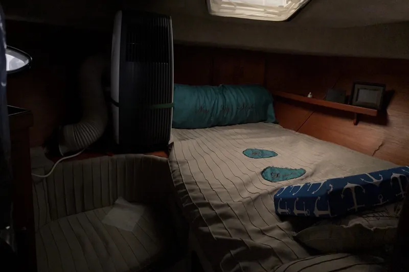 Slide: The Image of Cozy cabin interior of 1988 Cooper Prowler boat with bed and air conditioning unit. - 68