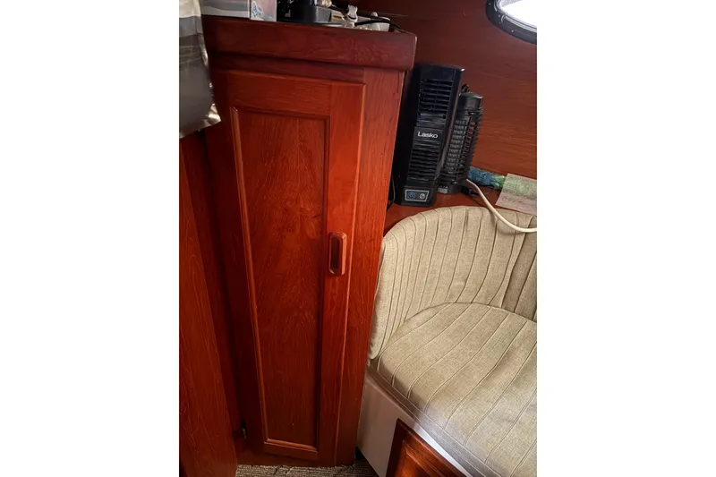 Slide: The Image of 1988 Cooper Prowler interior with wooden cabinet and cushioned seating. - 69